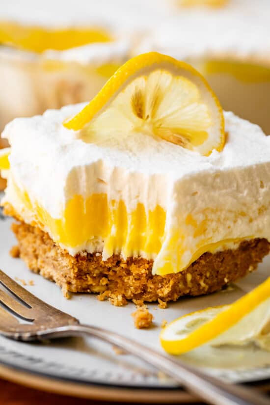 Lemon lasagna dessert with bite taken out.