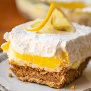 Layered lemon lush dessert on plate.