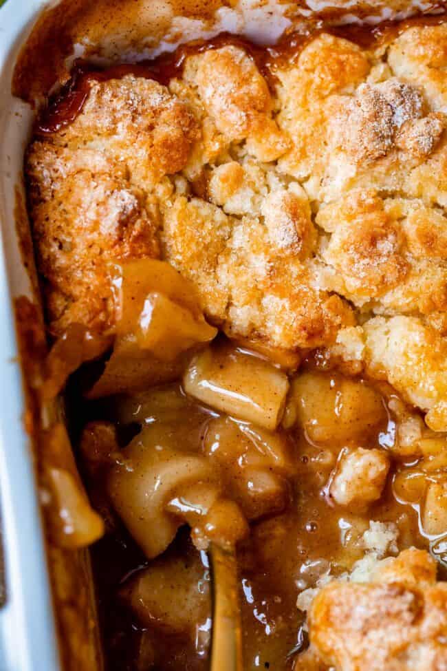 overhead shot of easy apple cobbler in a white dish, with a serving removed.