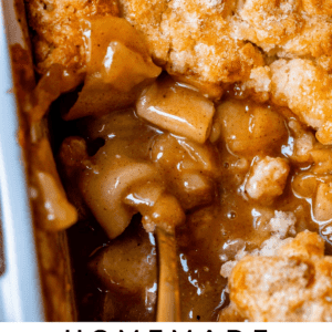 easy apple cobbler in a white casserole dish with spoon.