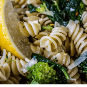 pasta and broccoli close up, with a wedge of lemon on the side.
