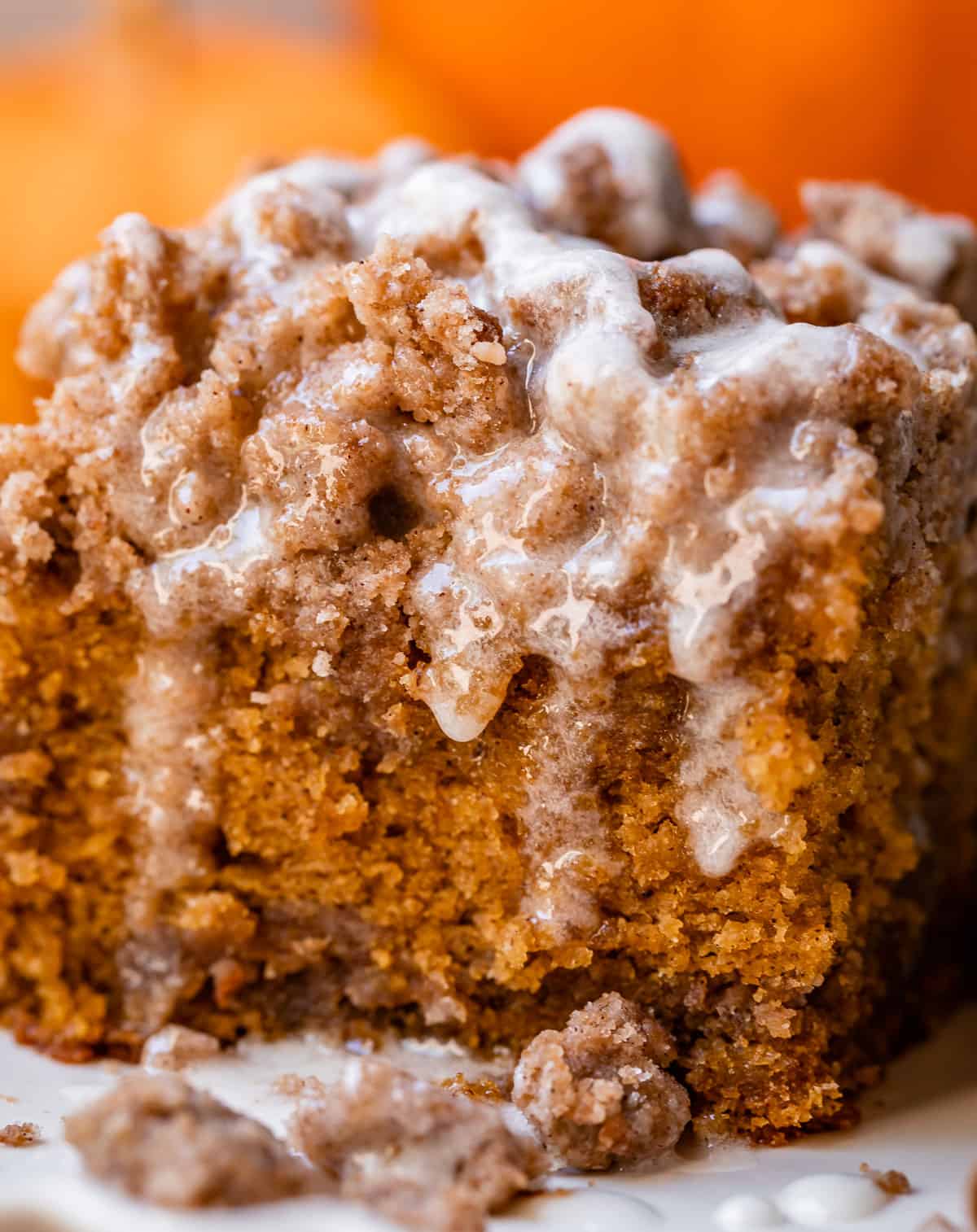 a slice of coffee pumpkin cake with streusel and glaze.