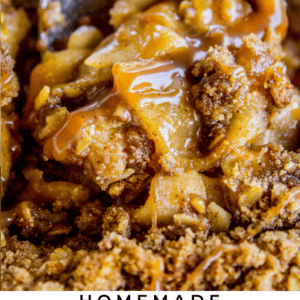 a large metal spoon dishing up apple crisp.