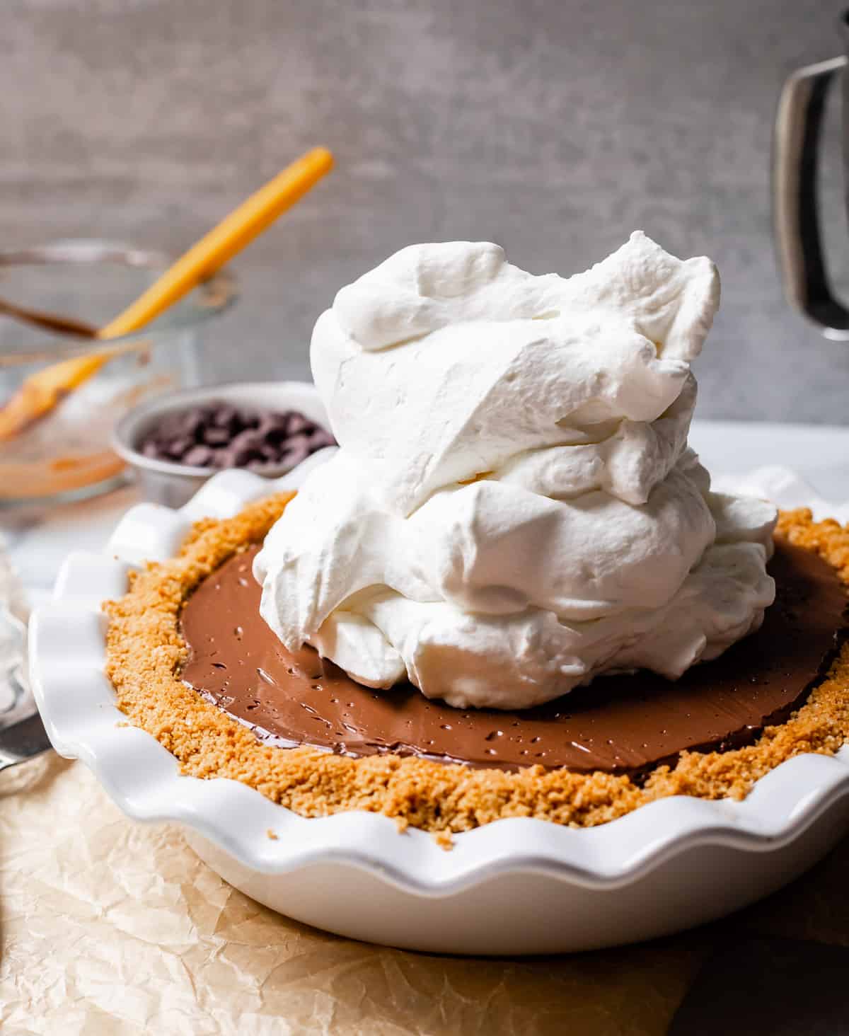 whipped cream piled high on a chocolate pie.