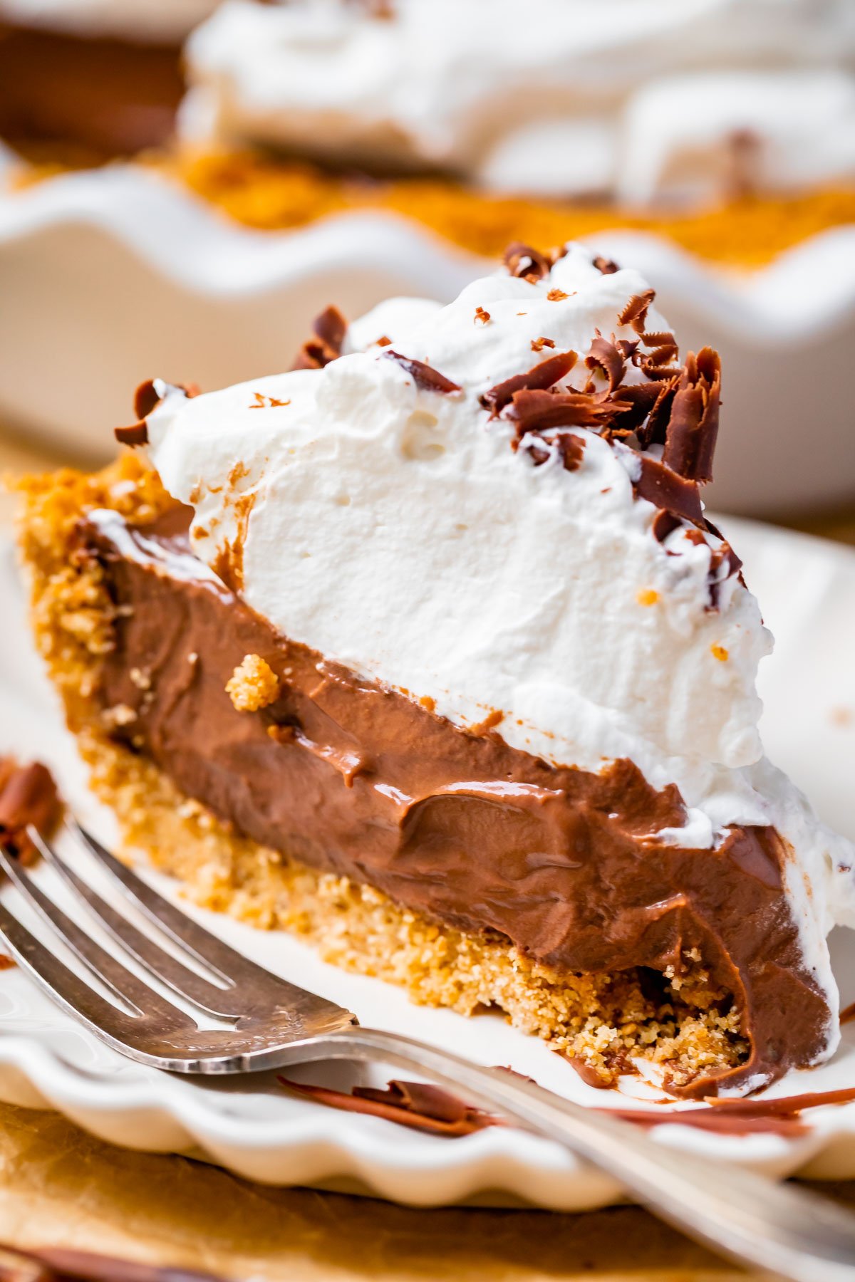 chocolate cream pie recipe on a white plate with a fork.