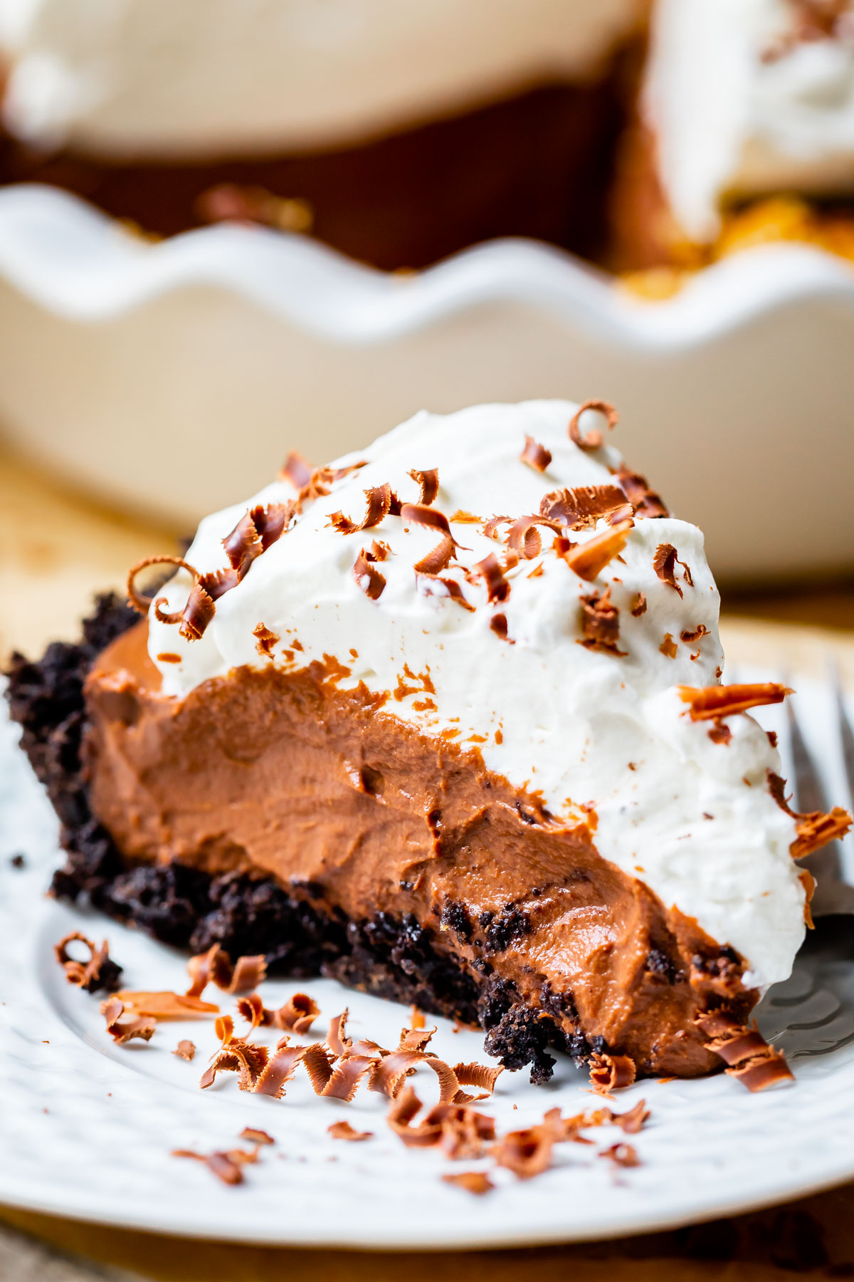 easy chocolate cream pie recipe with oreo crust on a white plate.