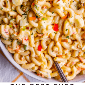 macaroni salad in a large serving dish with a metal spoon.