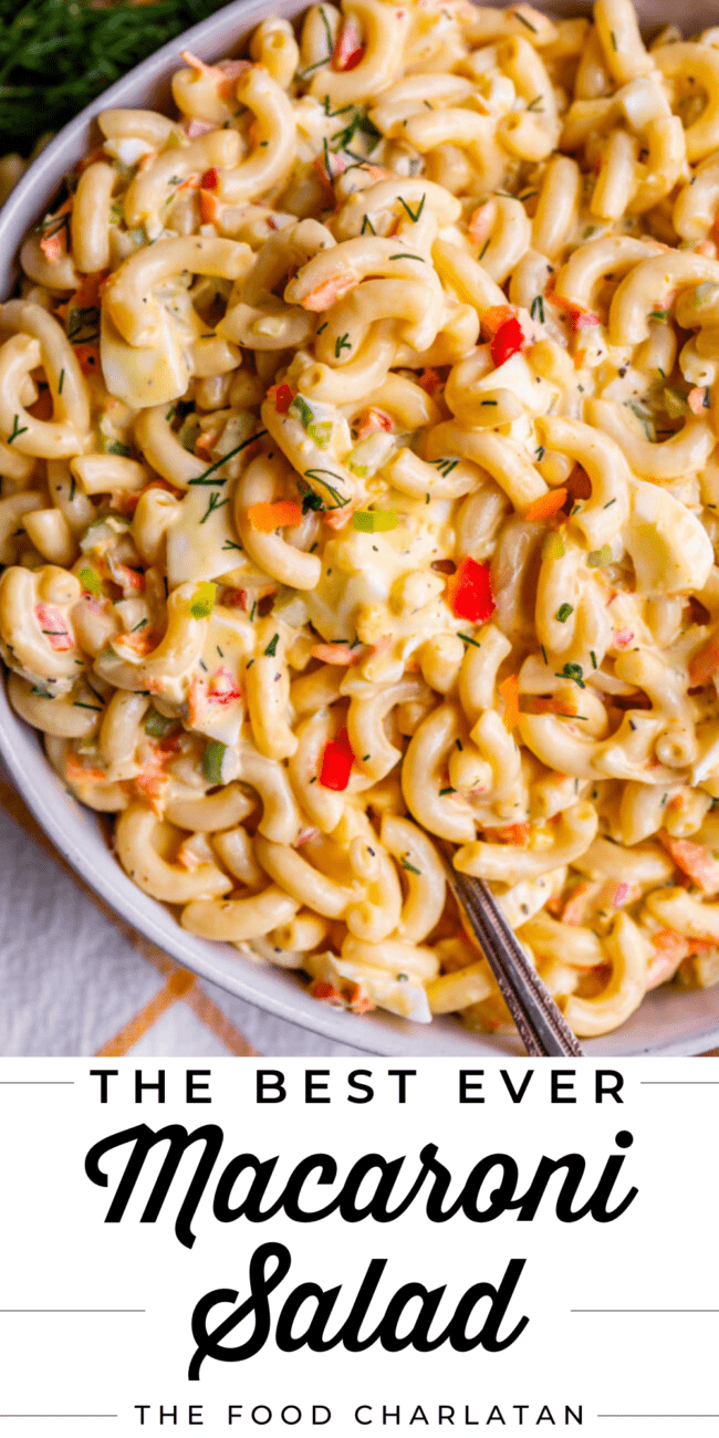 macaroni salad in a large serving dish with a metal spoon.