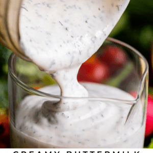 buttermilk ranch dressing being poured from a mason jar into a glass jar.