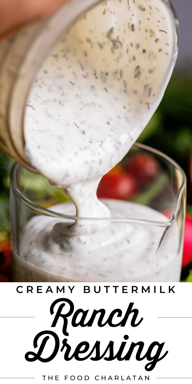 buttermilk ranch dressing being poured from a mason jar into a glass jar.