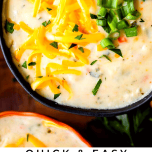 bowl of potato soup topped with cheddar and green onions.