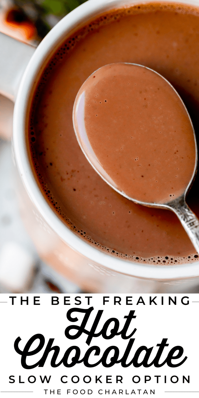 homemade hot chocolate in a mug, being lifted with a spoon.