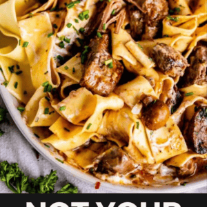A bowl of beef stroganoff with wide egg noodles, tender beef pieces, creamy sauce, and chopped chives, with the text “Not Your Average Beef Stroganoff” overlaid at the bottom, showcasing a delicious beef stroganoff recipe.