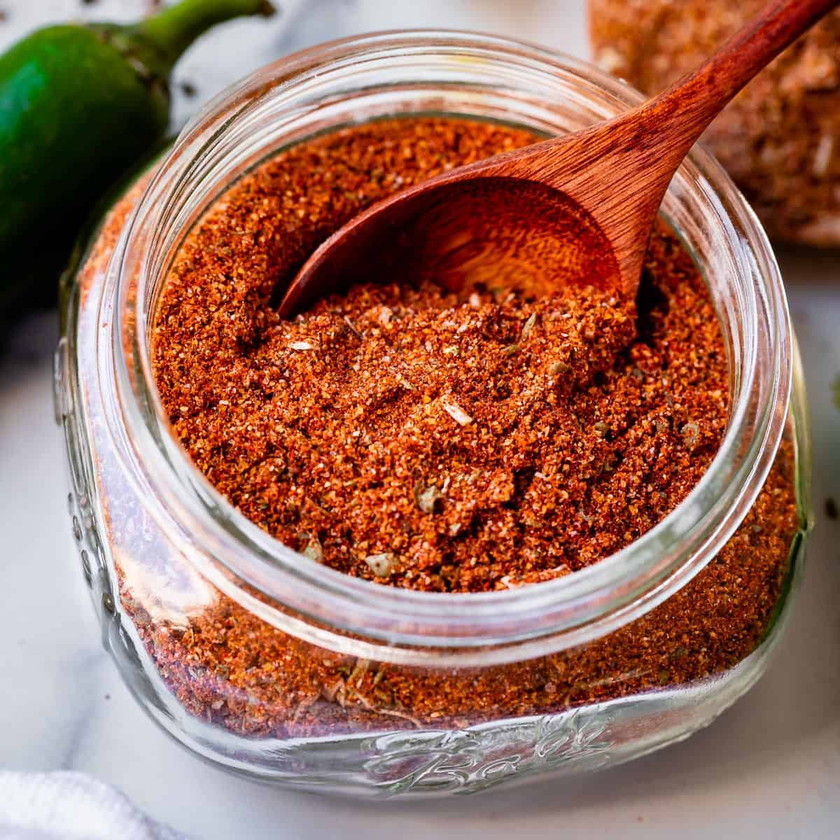 best taco seasoning in a jar with a wooden spoon.