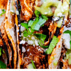 crock pot shredded chicken taco with double tortillas, green sauce, cilantro, and white cheese.