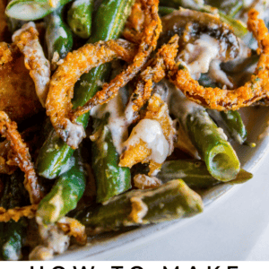 homemade green bean casserole with crispy fried onions in a white bowl.