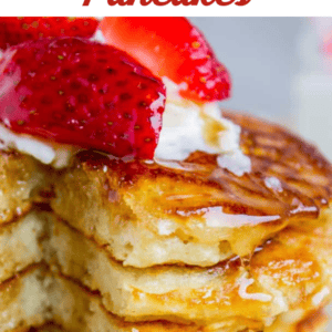 Fluffy Pancakes with strawberries and whipped cream on top