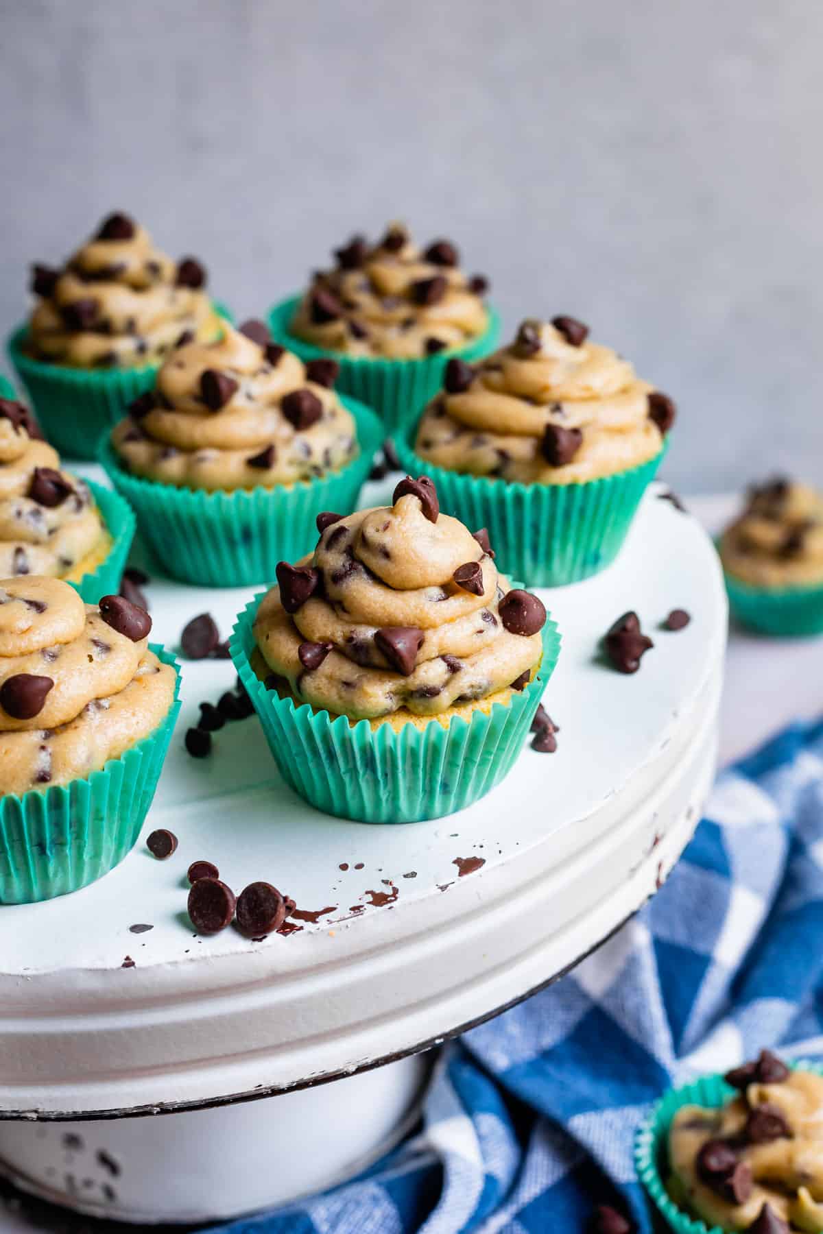 cupcakes on a cake stand with cookie dough frosting piled high on top.