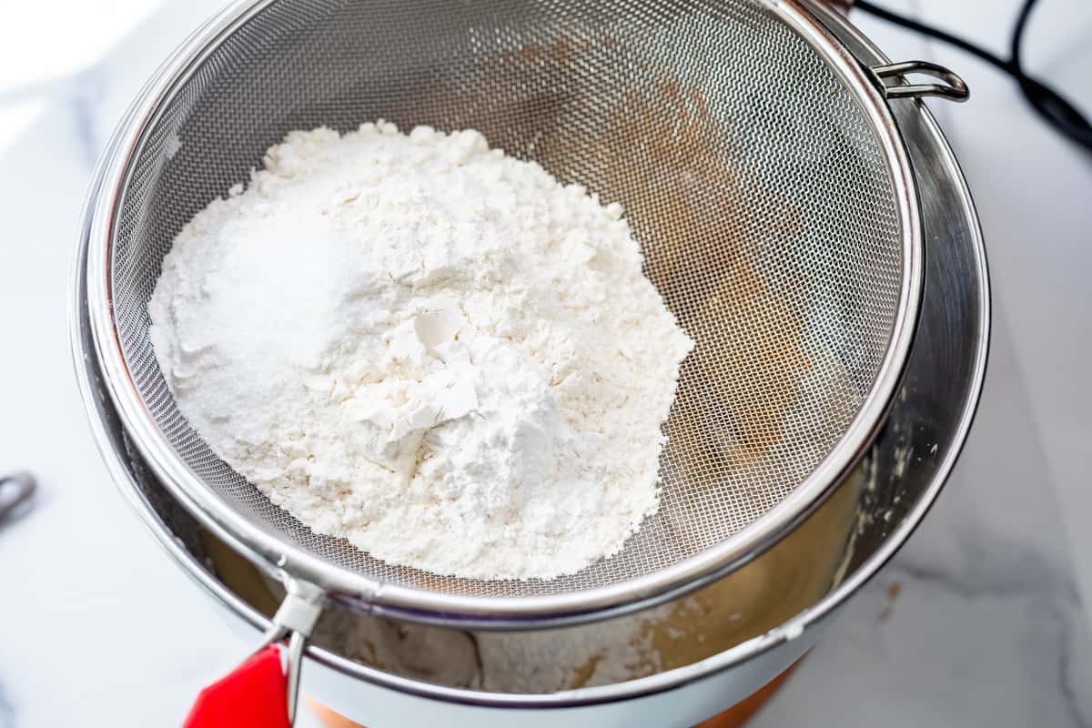 sifting flour to add to cupcake batter.