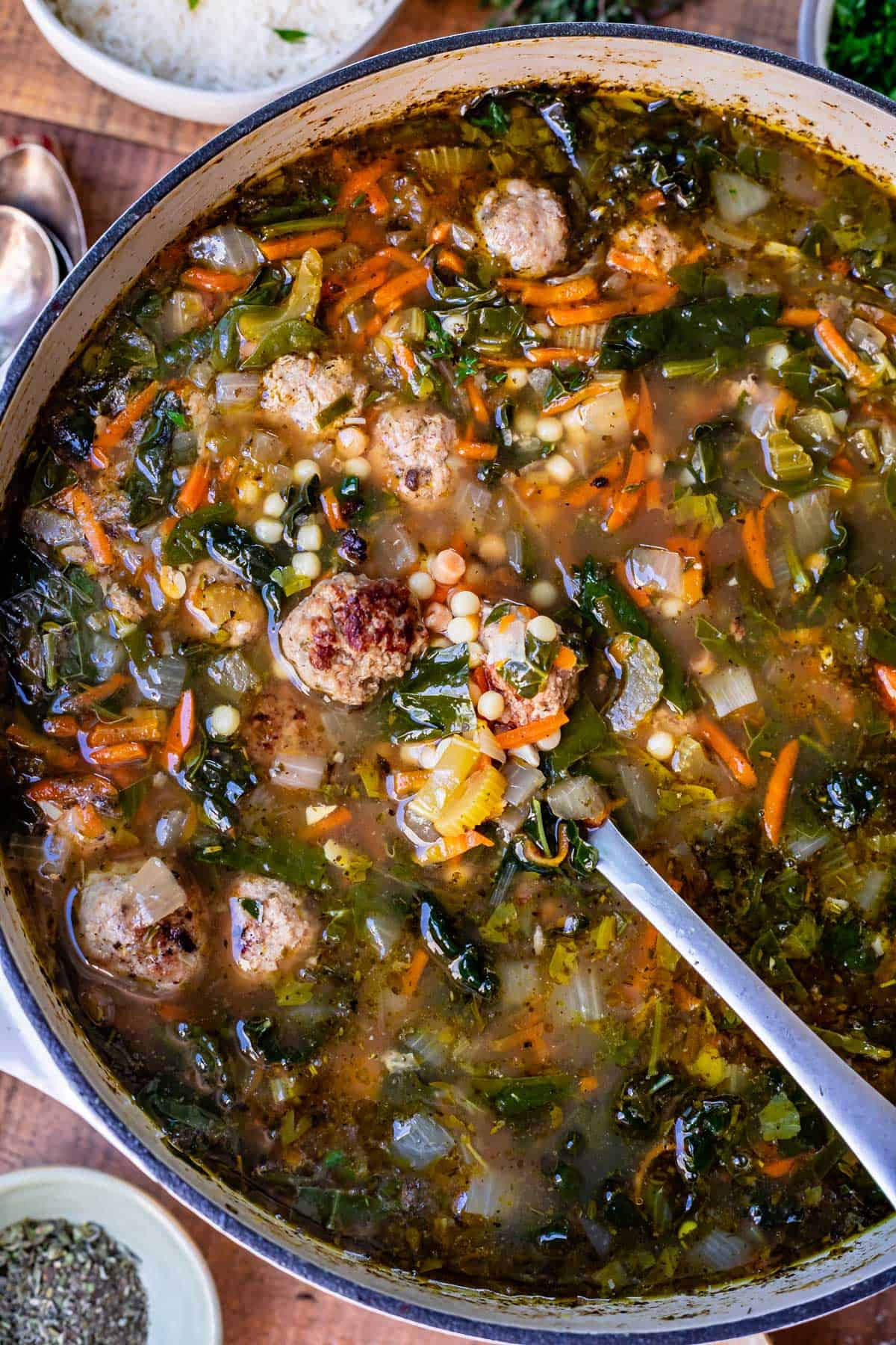 stockpot filled with italian wedding soup recipe made of rich broth, vegetables, and tiny pasta and meatballs.