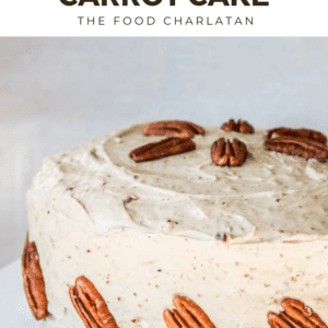 carrot cake frosted and decorated with pecans.