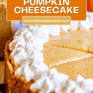 A close-up of a no bake pumpkin cheesecake topped with whipped cream, featuring a label that reads No Bake Pumpkin Cheesecake and the website thefoodcharlatan.com in white text.