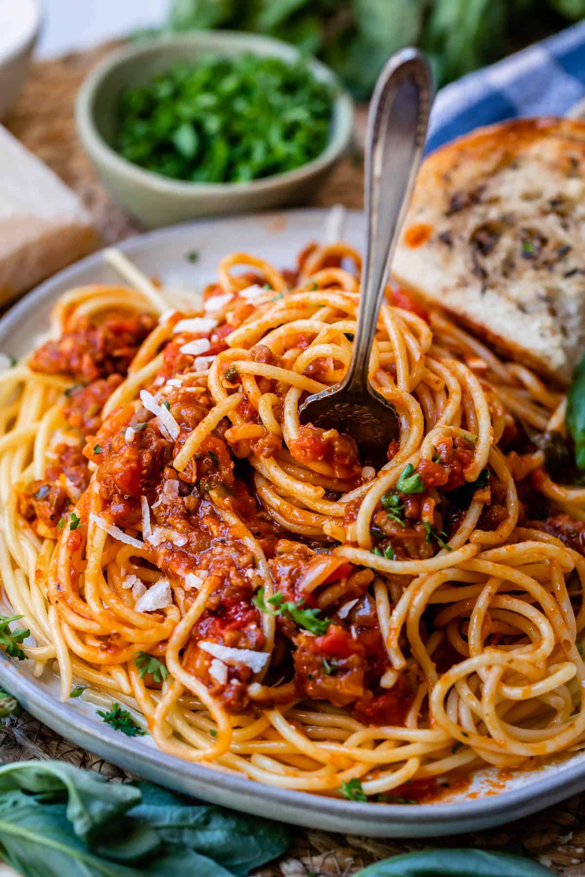 plate filled with spaghetti topped with easy homemade spaghetti sauce, with a fork stuck tines in.