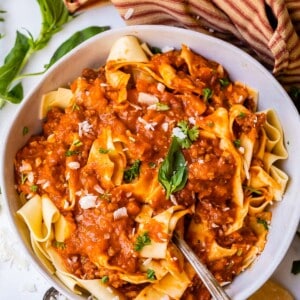 bowl filled with wide noodles topped with homemade bolognese sauce.