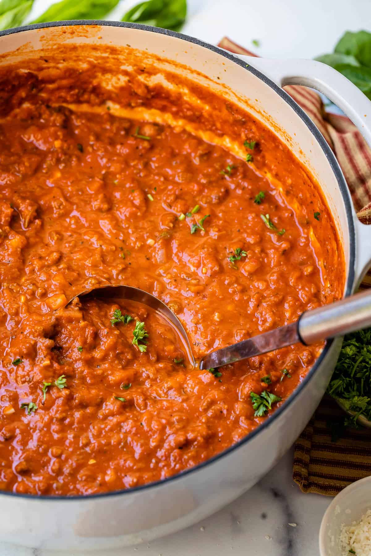 white stockpot filled with velvety, thick and rich homemade bolognese sauce.