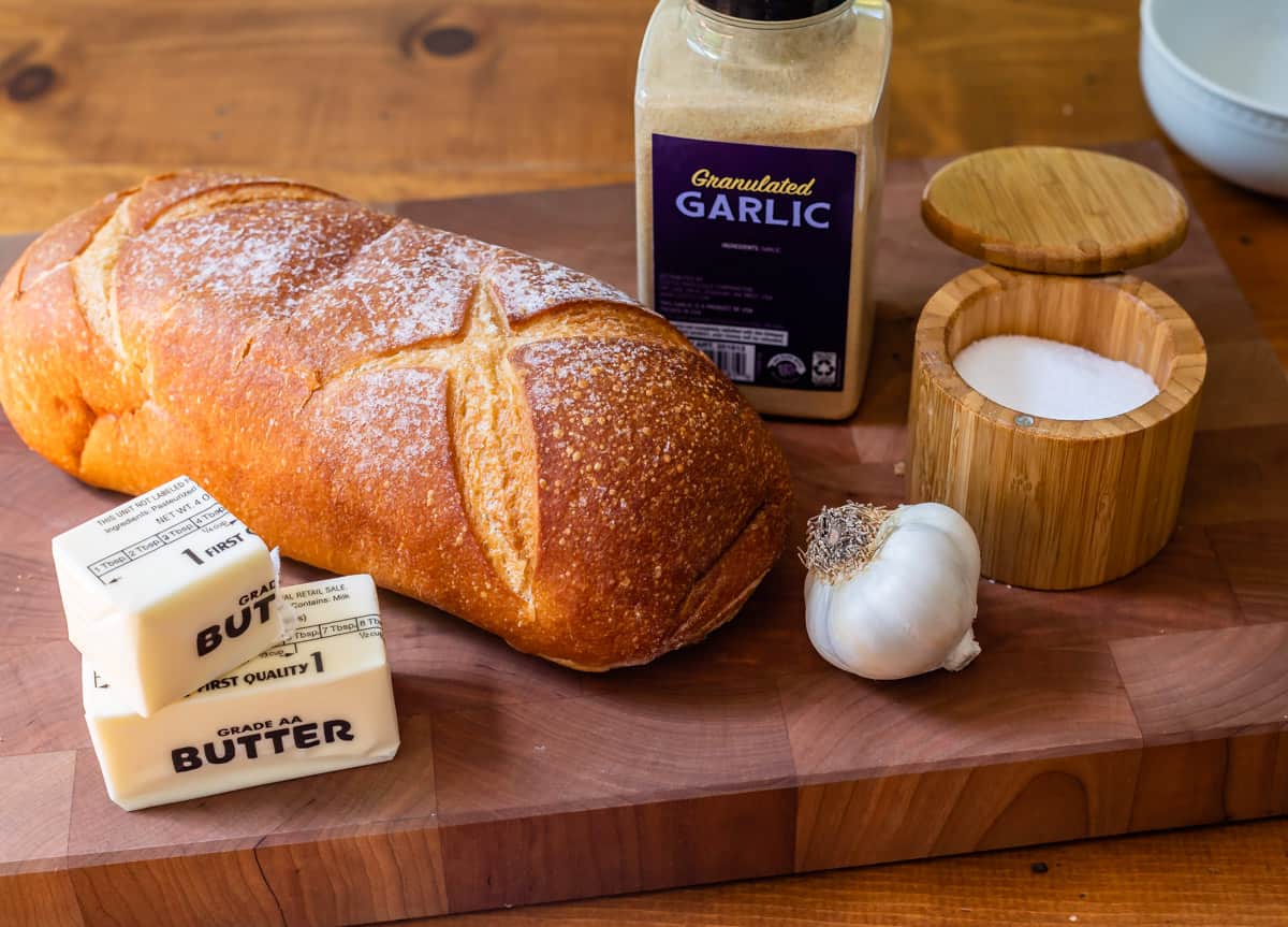 ingredients for garlic bread - bread, butter, salt, garlic, and granulated garlic.