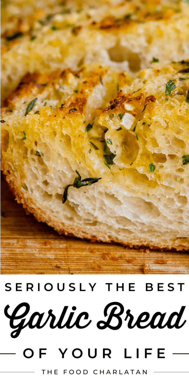 close up of the side of a piece of garlic bread with parsley.