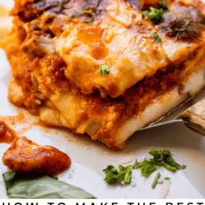 placing square of homemade lasagna on a white plate.