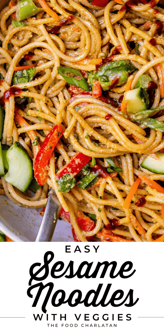 cold sesame noodles with cucumber and bell pepper, in a white bowl with a spoon. and