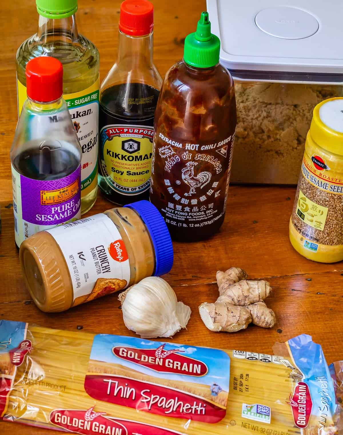 a group shot of all the ingredients to make sesame noodles from spaghetti noodles.