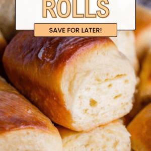Close-up of golden brown, soft and fluffy parker house rolls stacked together. Text reads: Soft & Fluffy Dinner Rolls. Save for later! The Food Charlatan.