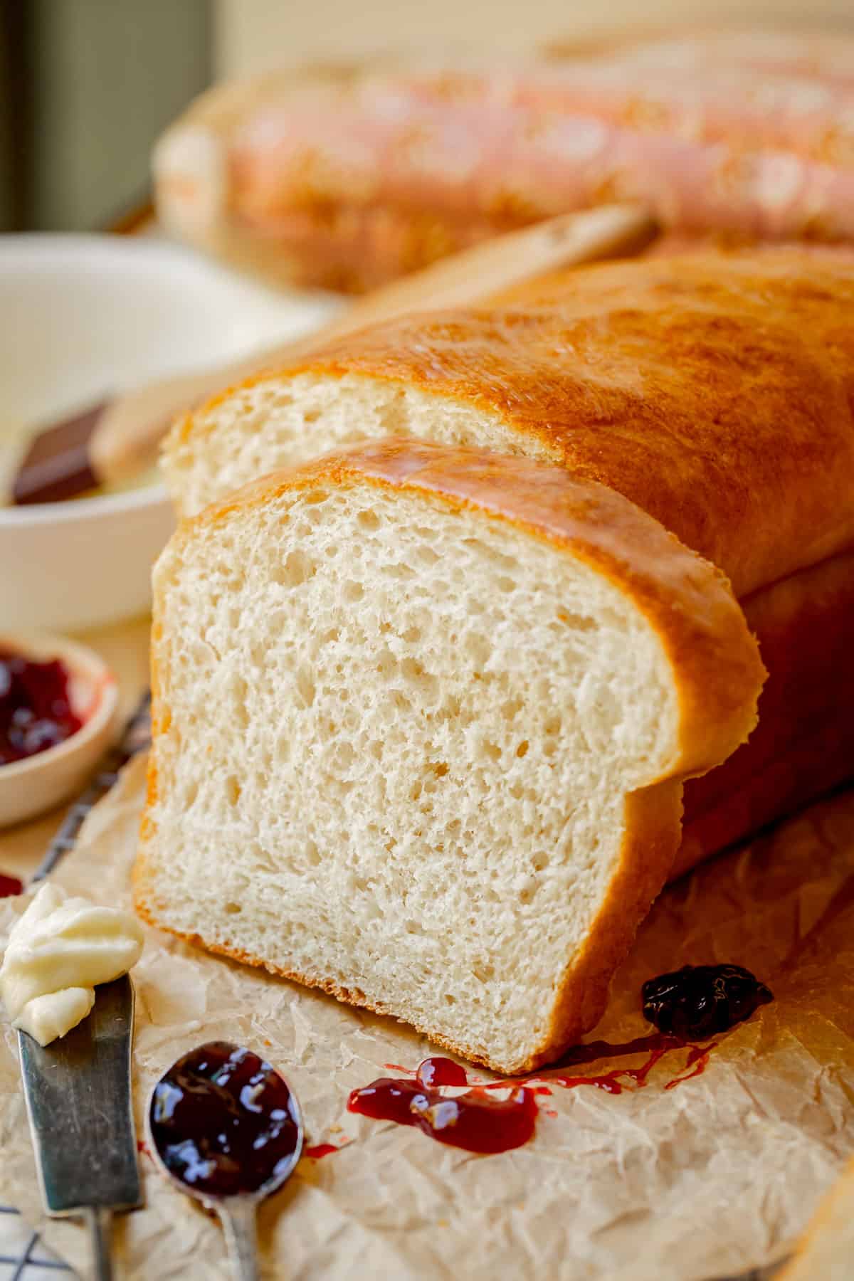 a thick slice of easy white bread leaning against the remaining loaf.
