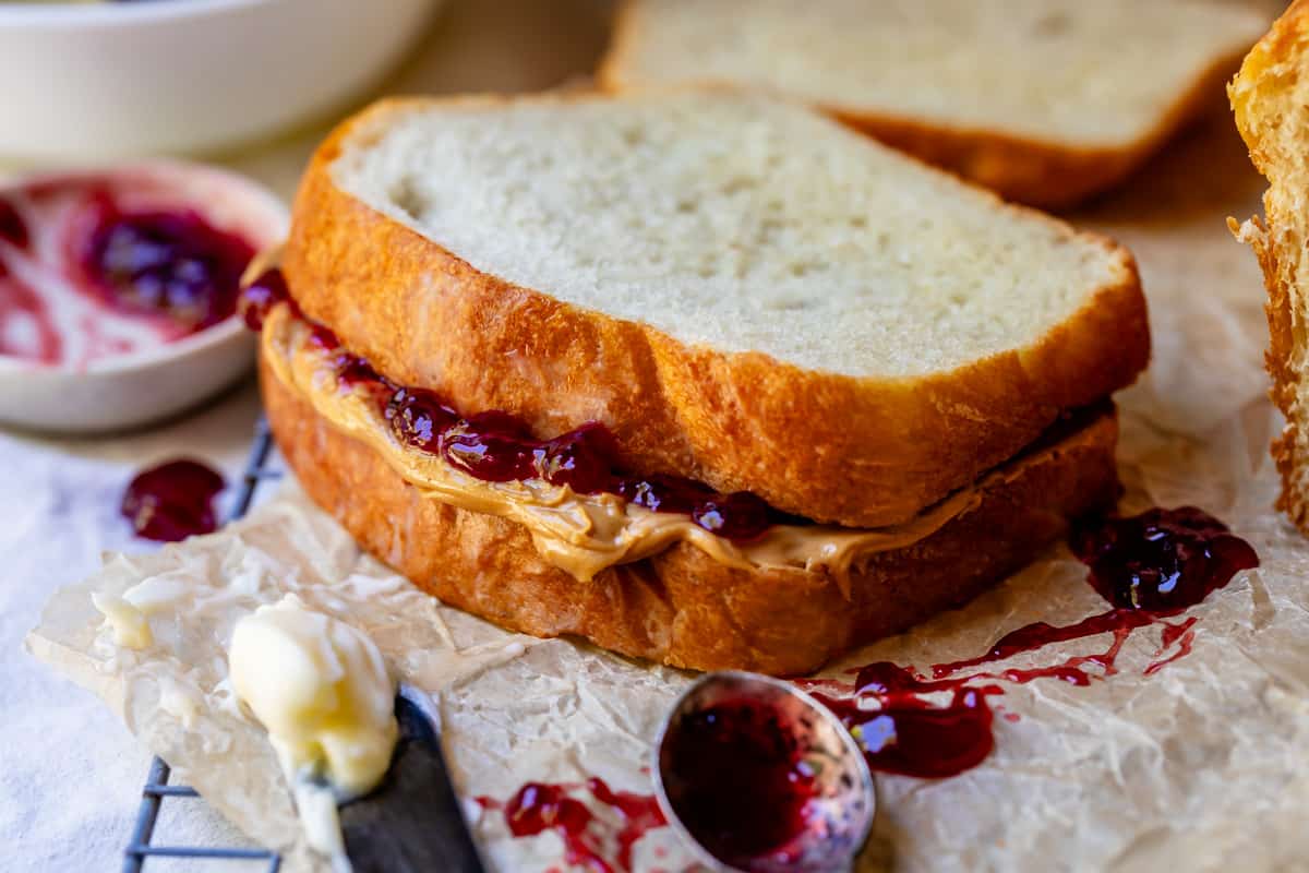close up of a peanut butter and jelly sandwich using slices of homemade white bread.