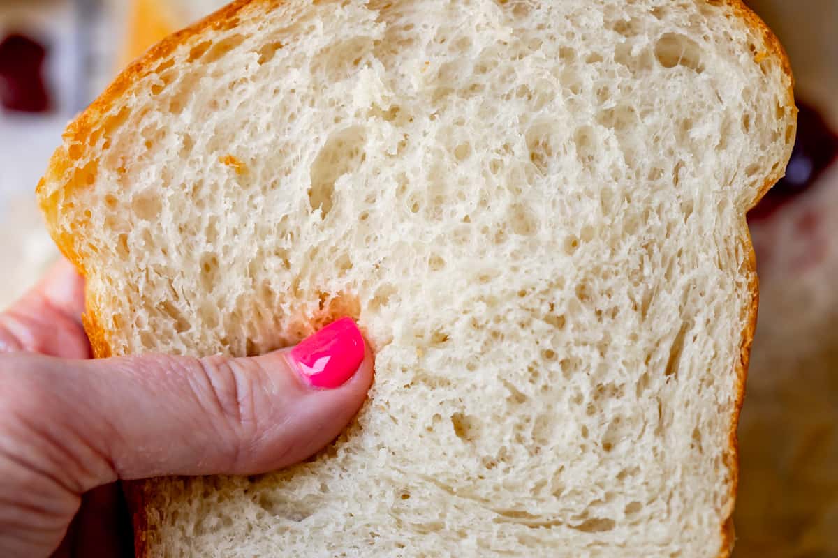 close up of a slice of white bread showing all the air pockets that make it light and fluffy.