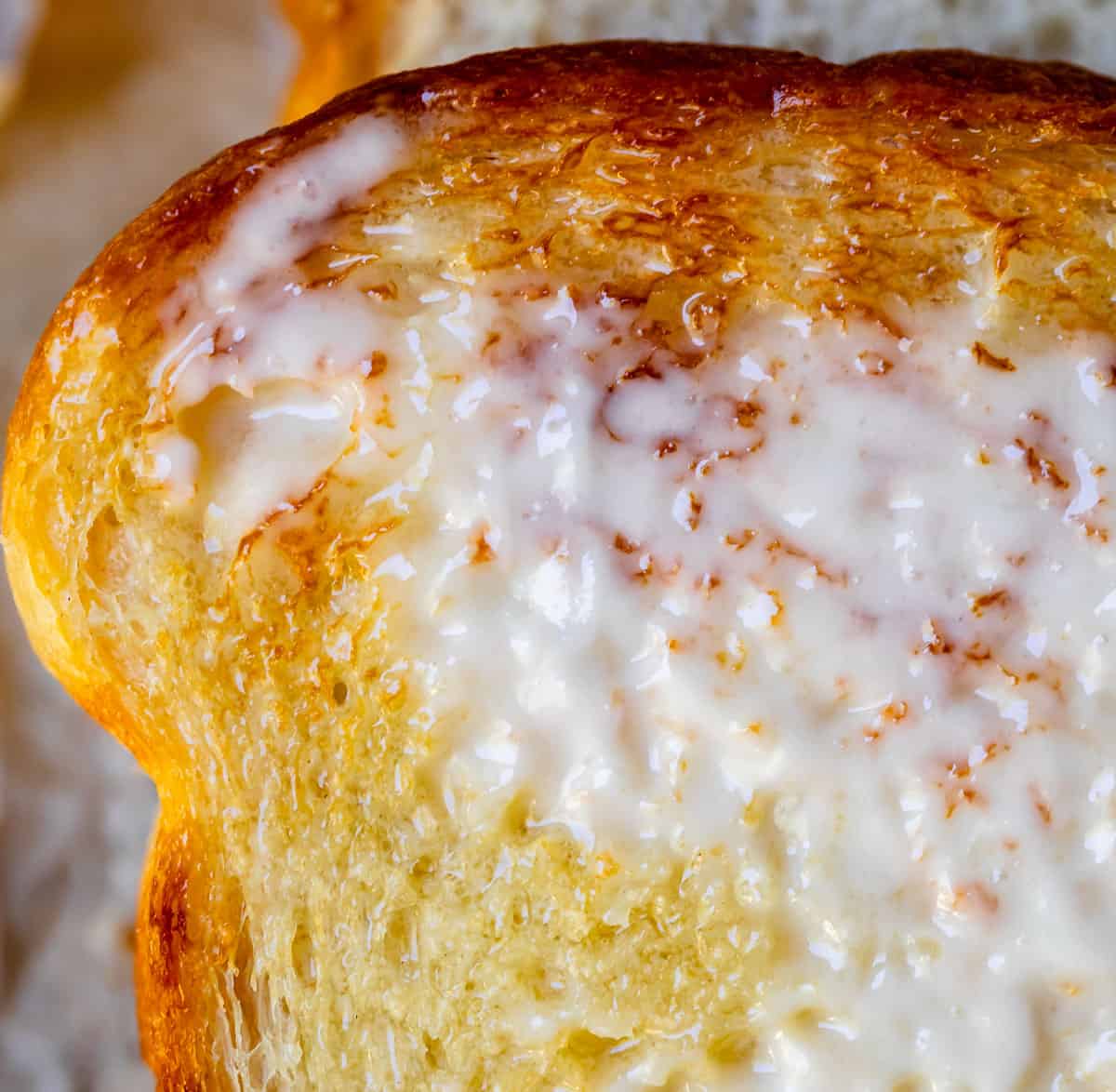 a piece of toasted easy white bread with butter melting into the bread.