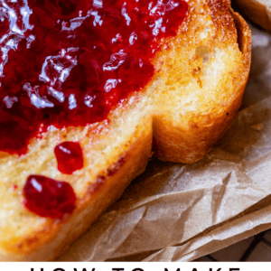 toasted and buttered white bread with jam, on parchment paper.