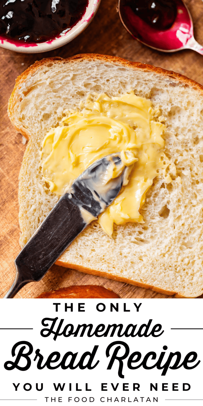 a butter knife spreading softened butter on a single piece of homemade white bread .