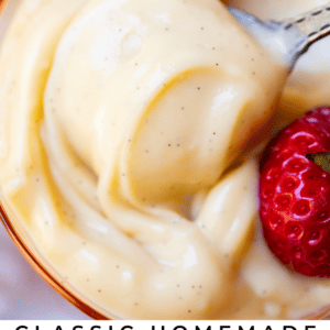 Close up of a spoon lifting a bite of vanilla pudding from a pink glass serving dish.