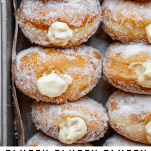 sugar rolled homemade donuts on parchment paper with text "fluffy Bavarian cream-filled donuts".