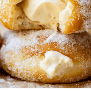 two stacked donuts with a bite taken with text "homemade Bavarian cream donuts".