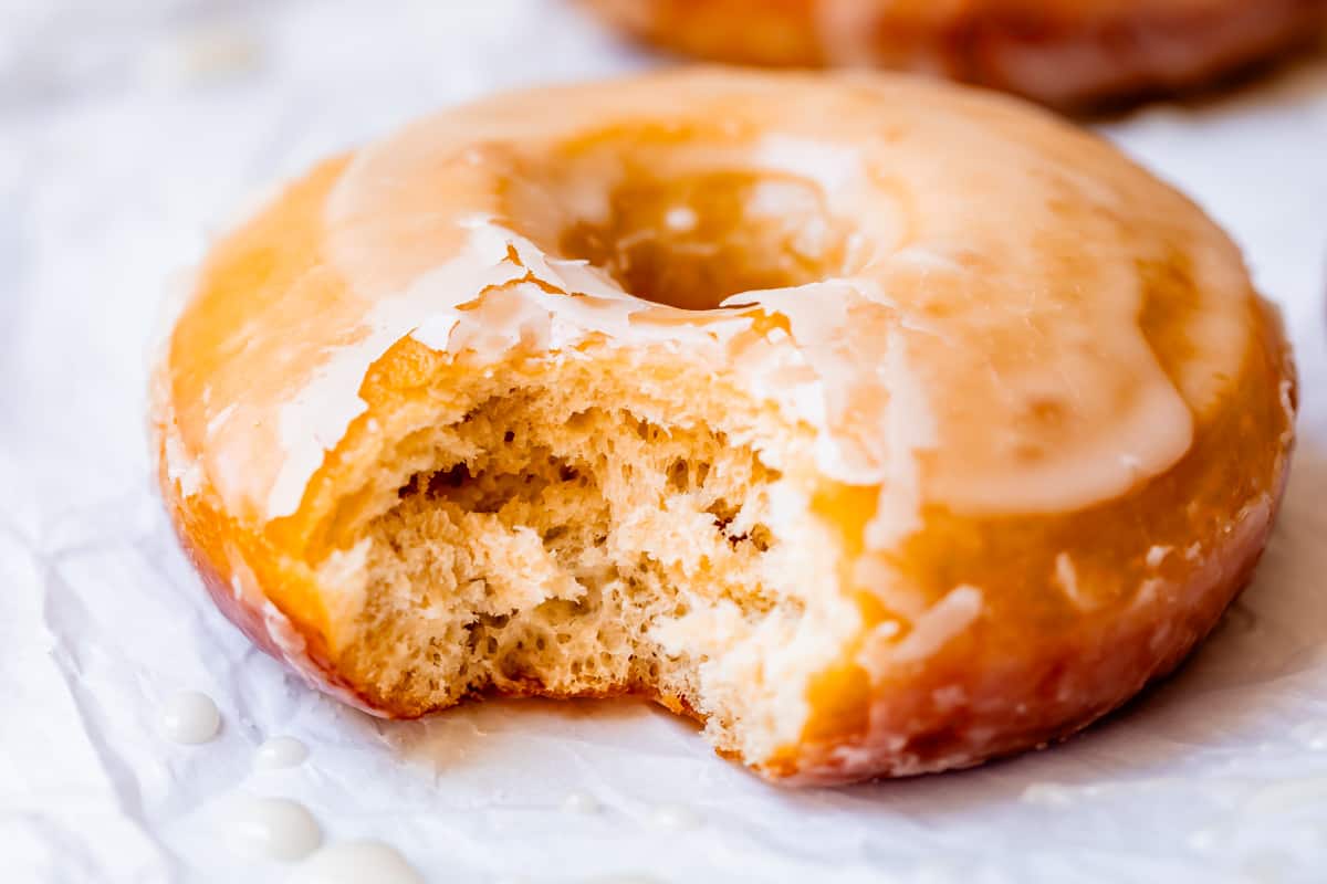 the inside of a cut donut showing how light and airy the yeast donuts are.