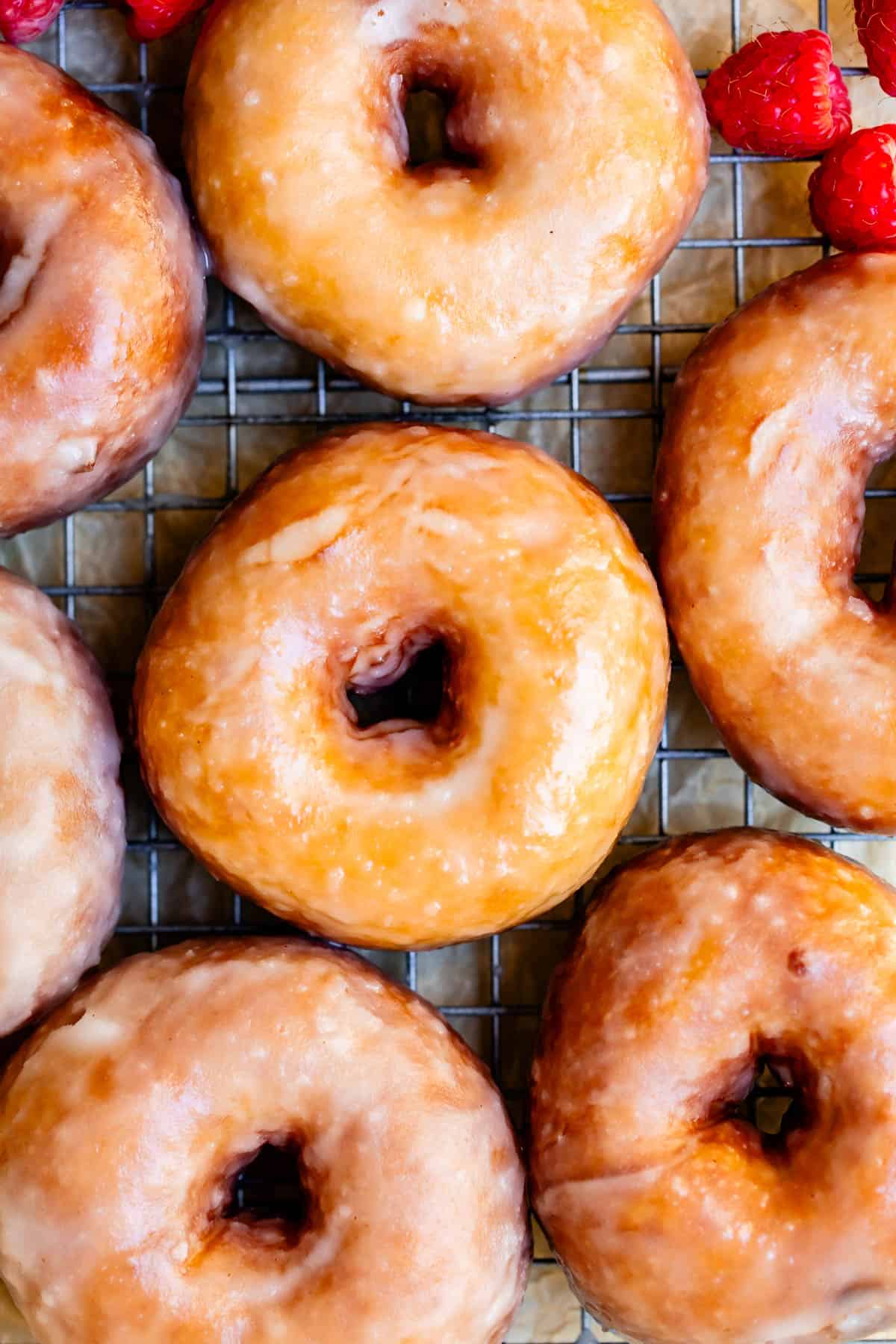 straight overhead shot looking down on cooling rack of ready to eat donuts.