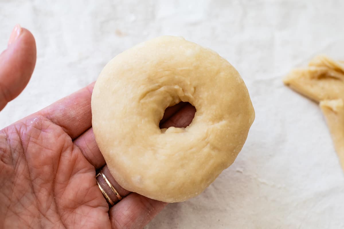 Hand shaped from scratch donut dough ready for its second rise before frying.