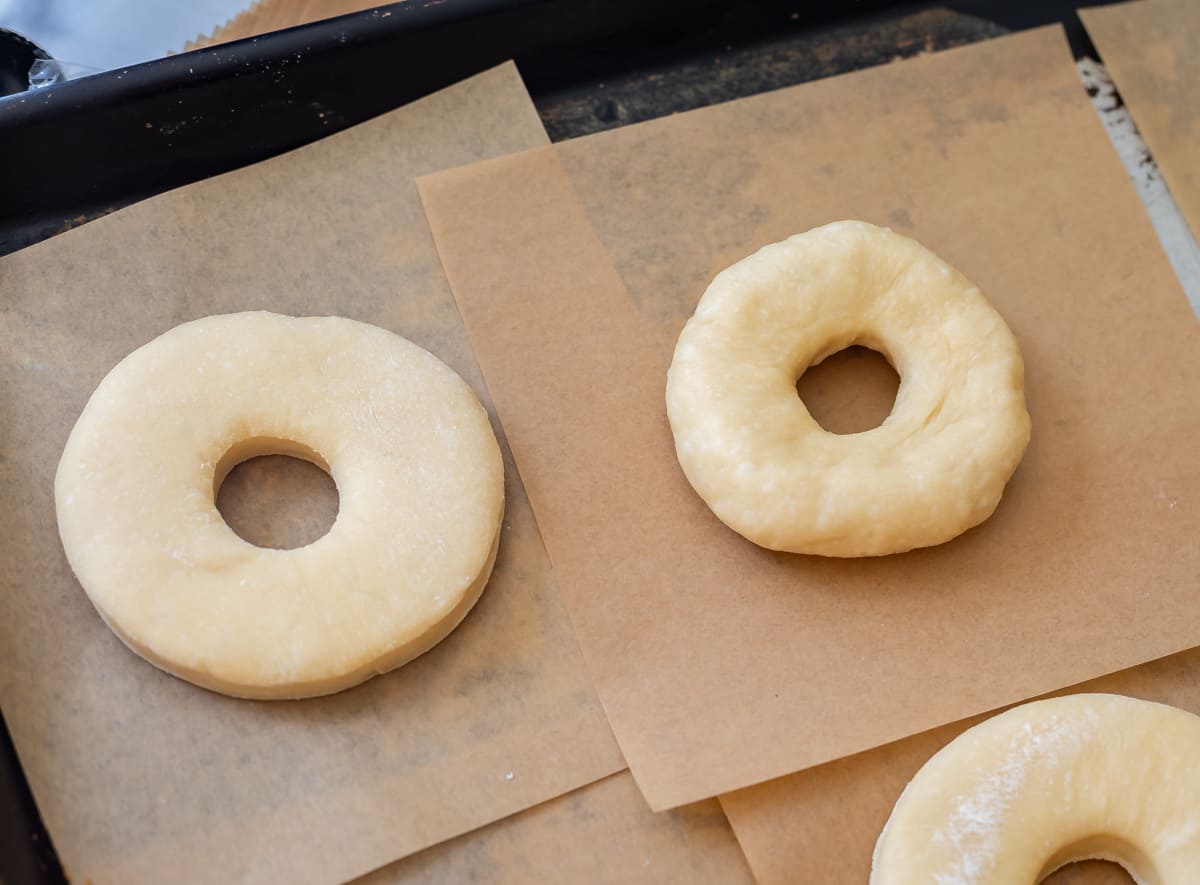 on left, flatter donut from the donut cutter, on right, fluffier donut that was hand shaped.