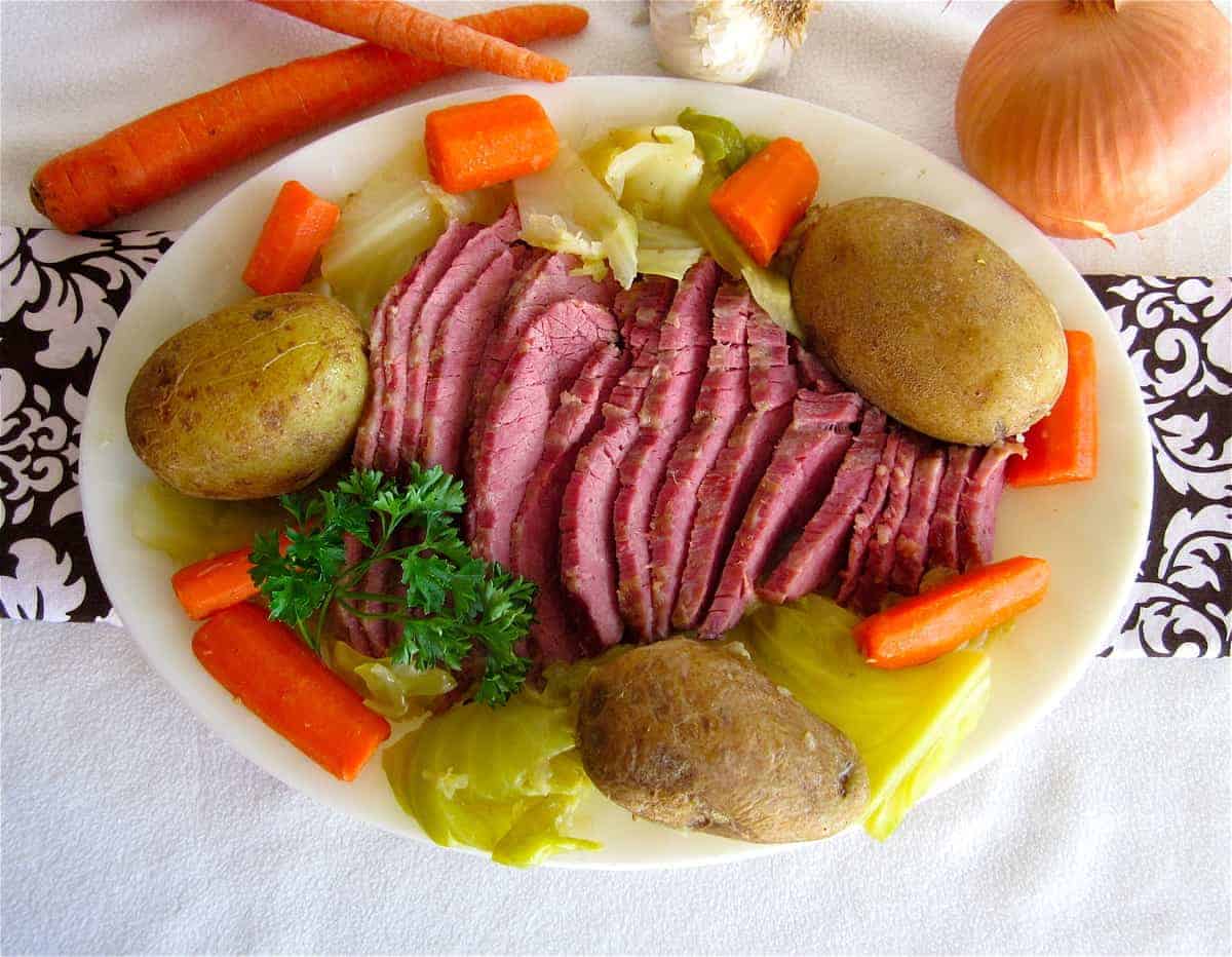 corned beef and cabbage on a plate with potatoes and carrots