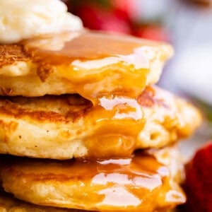 buttermilk syrup recipe drizzled over pancakes with butter.
